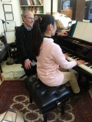Yeaji Kim and Professor Todd Welbourne at a piano.